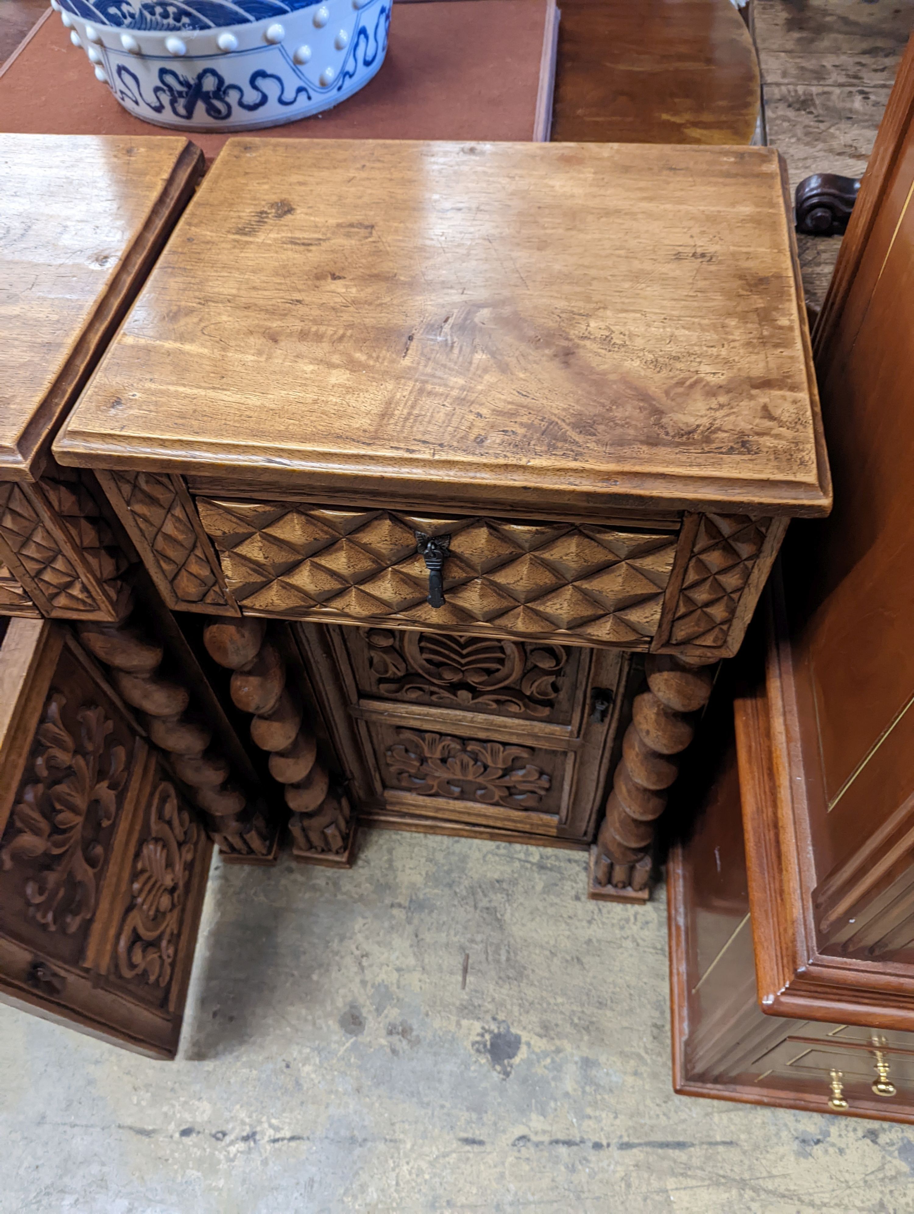 A pair of Spanish style carved walnut bedside cabinets, width 48cm, depth 38cm, height 79cm